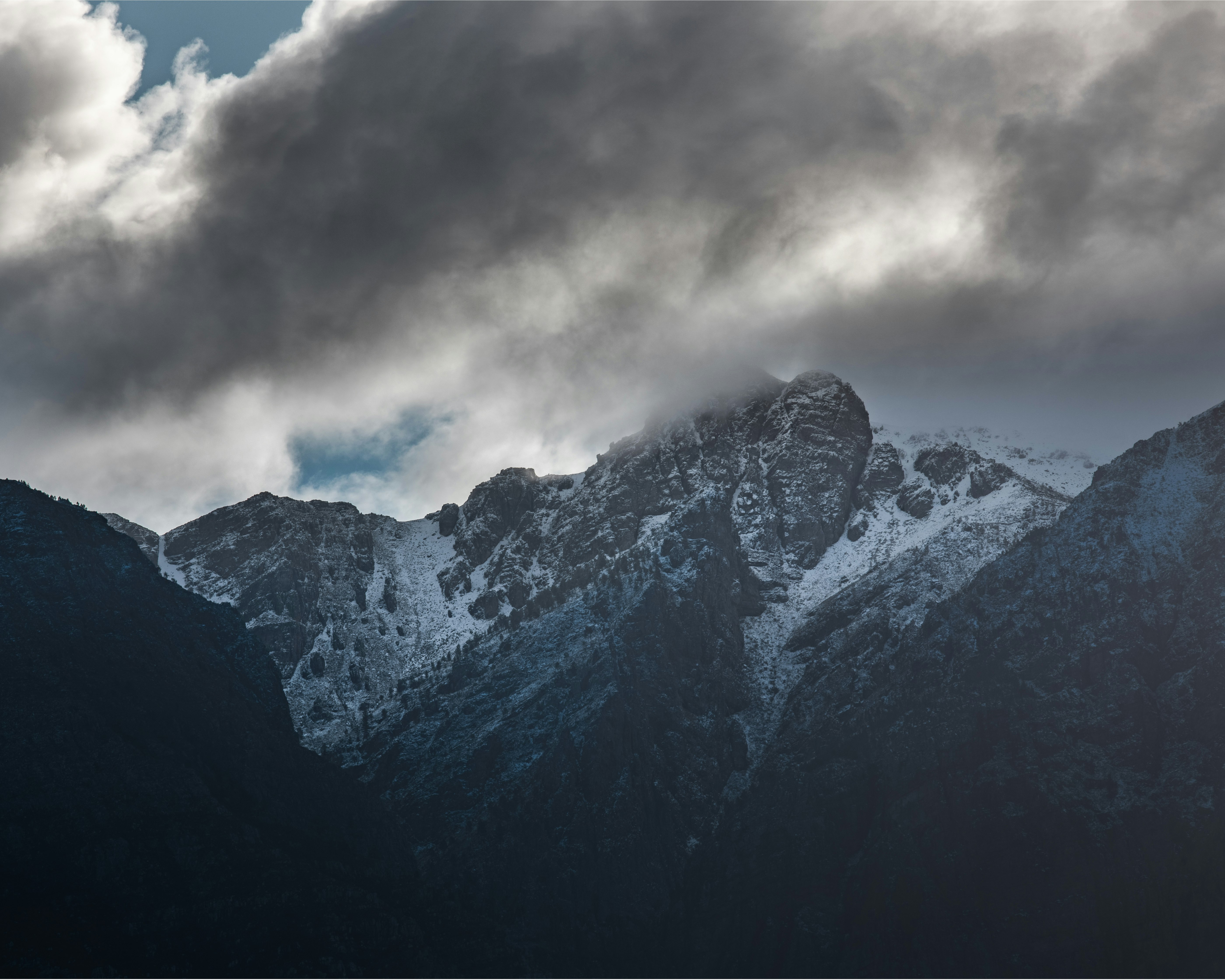 snow covered mountain under cloudy sky during daytime